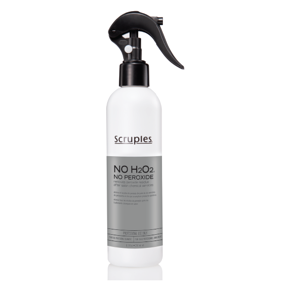 A bottle of Scruples No H2O2 (No Peroxide) with a spray nozzle, primarily in white color with black text and accents.